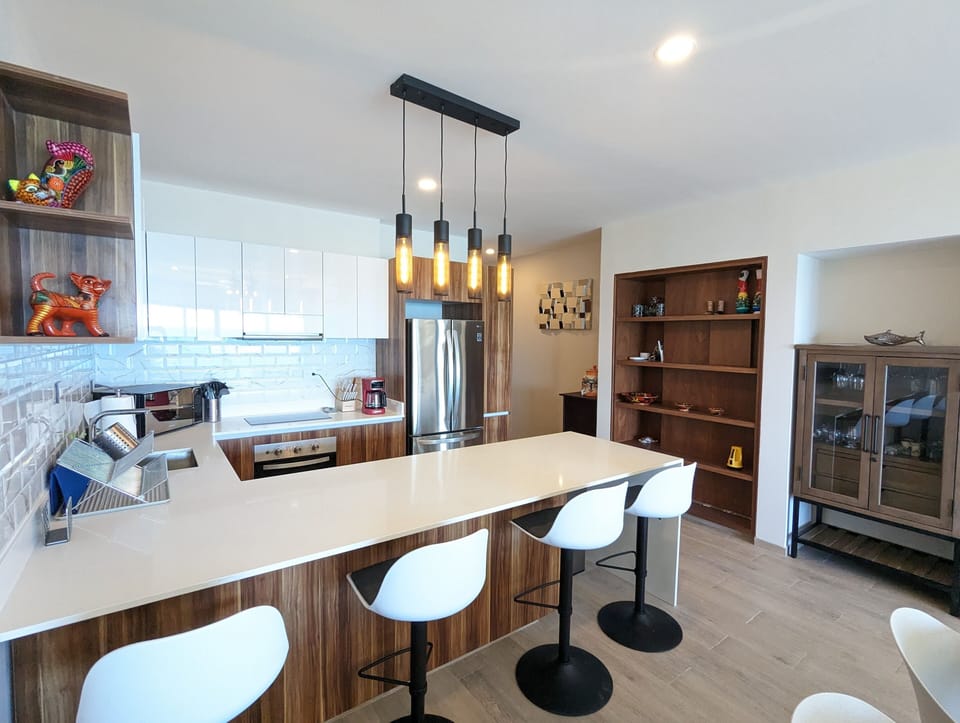 The bar cabinet has wine glasses, margarita glasses, martini glasses, and even beer mugs.