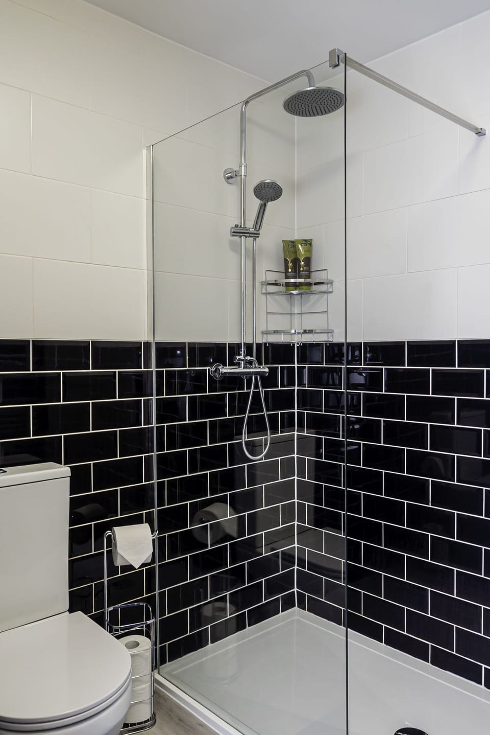Our bathroom has an elegant glass divider that creates a distinct separation between the bathing and toilet areas