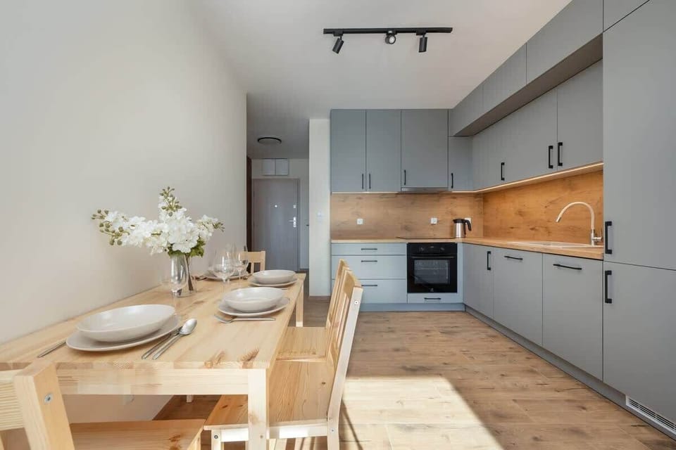 A wide-angle view of the open-plan layout, connecting the kitchen, dining, and living areas seamlessly.

