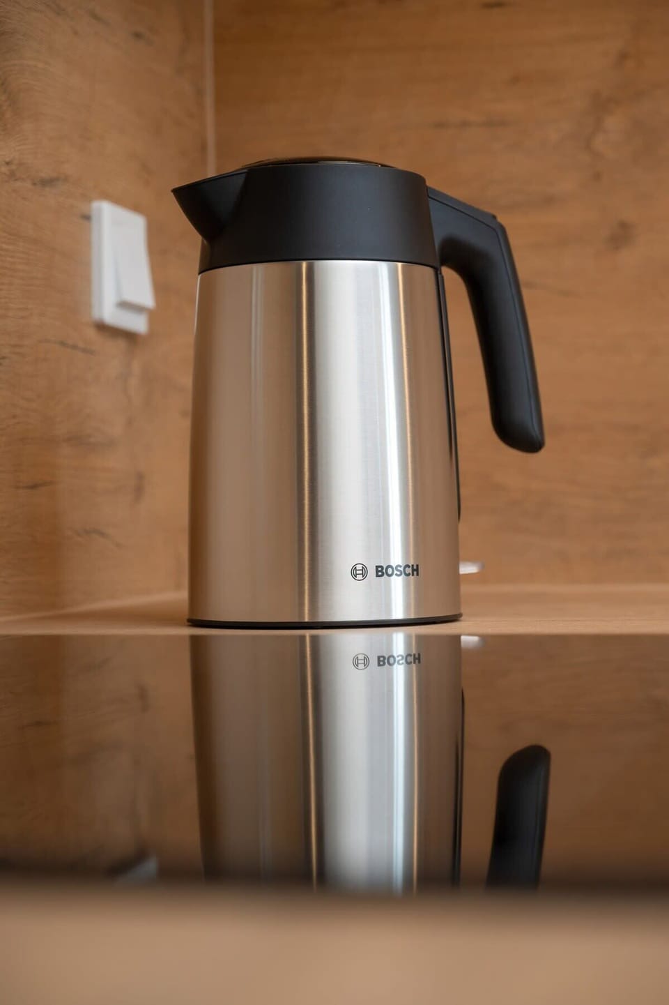A close-up of a kettle on the kitchen counter, blending modern design with practicality.
