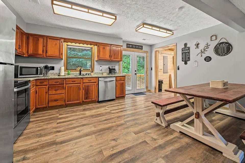 Cook up cabin favorites in this spacious kitchen with modern appliances and rustic wood cabinets.