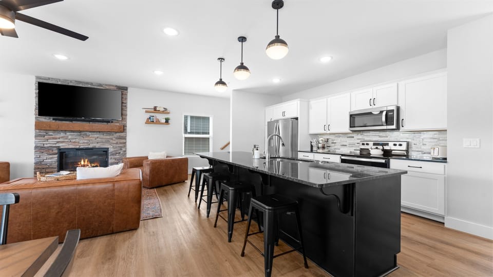 Open-concept kitchen with a large island and stainless appliances.