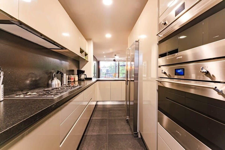 Sleek kitchen with high-end appliances, offering a minimalist and relaxed cooking space.