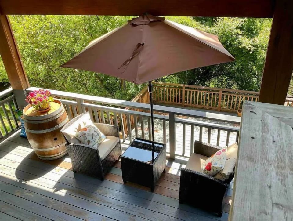 Outdoor deck seating for two with two additional chairs.