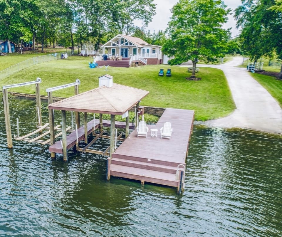 Large, fully fenced-in property w/private dock, boat ramp, fire pit, & furniture