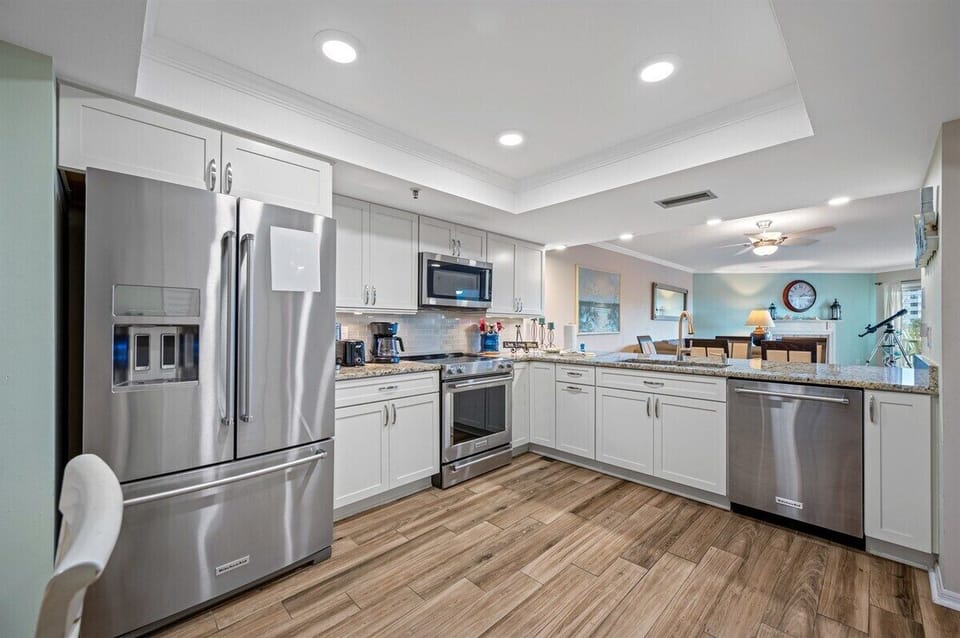 Fully equipped kitchen with granite countertops, stainless steel appliances, and plenty of counterspace for cooking and preparing meals