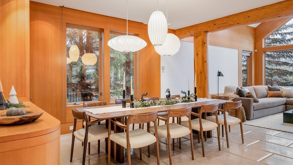 - Elegant dining space featuring modern wood interiors and forest views  
- Long table setup perfect for shared meals and festive gatherings  
- Surrounded by natural light for an inviting mountain dining experience  