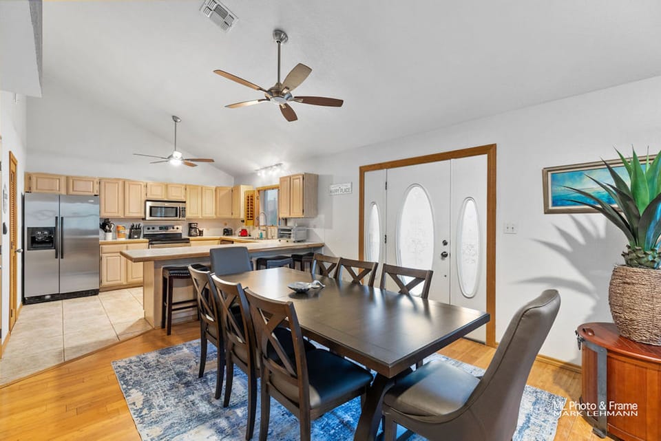Dining table set for 8 and can seat 12 with table leaf and spare chairs from game room. 4 additional seating areas at the breakfast bar.