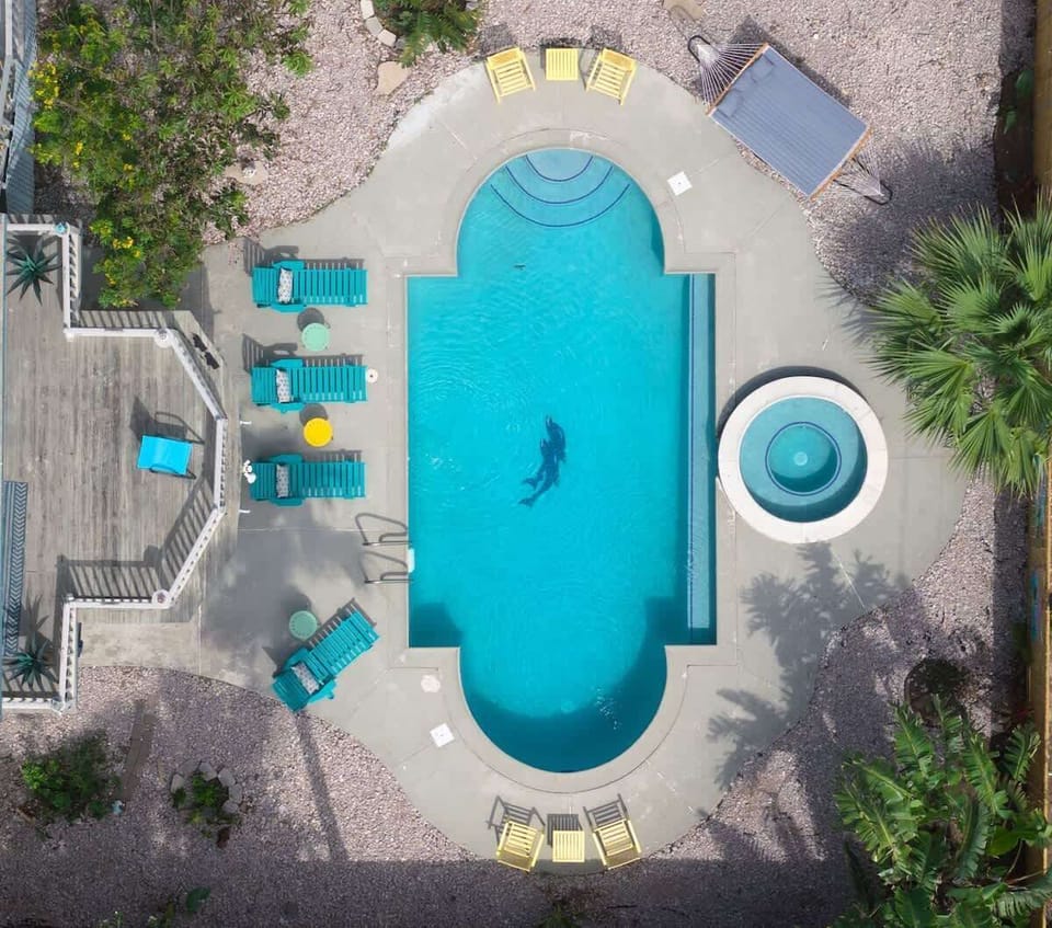 Large private backyard centered around the pool and hot tub, with plenty of room for outdoor dining, lounging, and family gatherings throughout your stay.