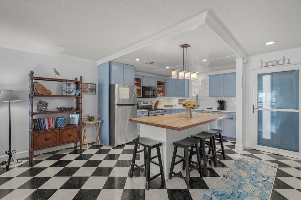 Full kitchen, with new appliances and a large island for storage and food prep.