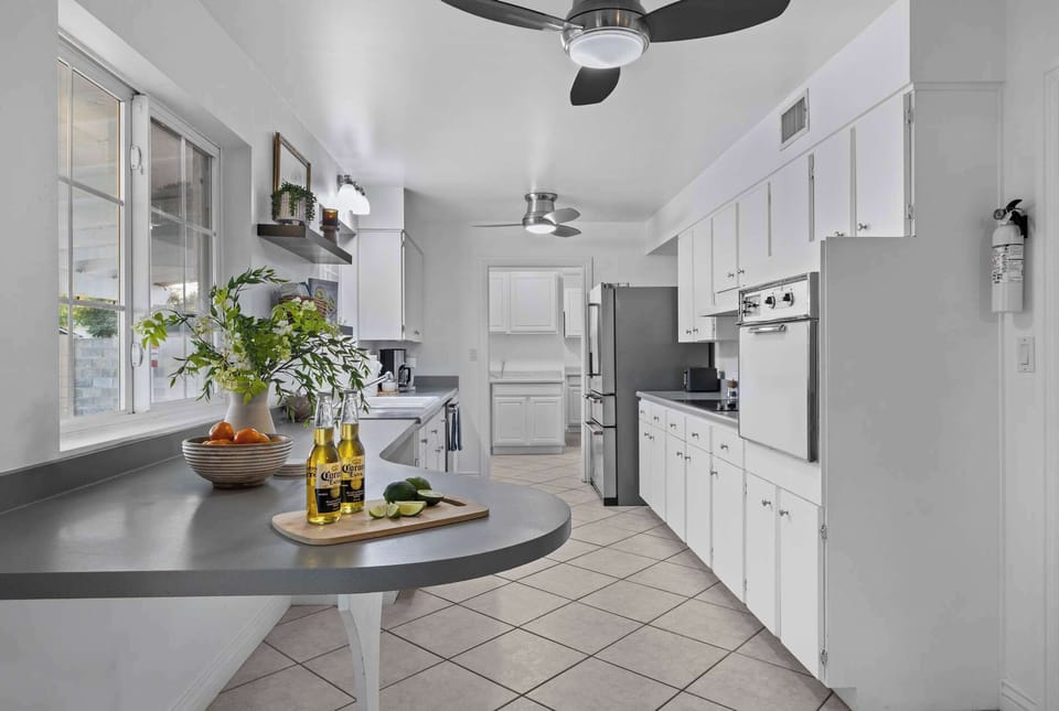 Stocked kitchen with a sit up countertop.