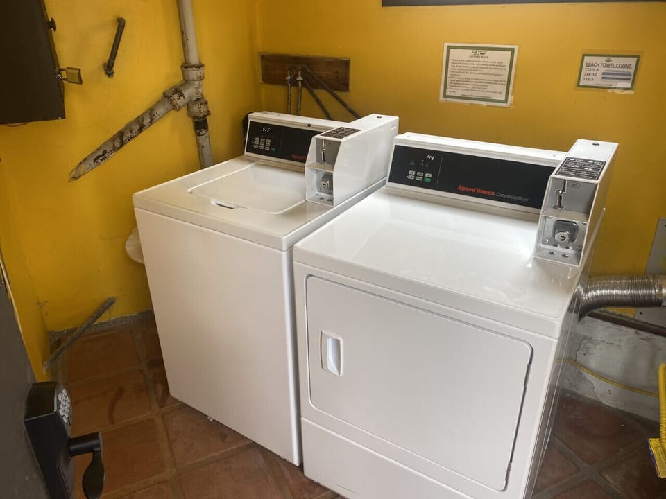 Shared laundry room located at the back of the building under the back staircase.