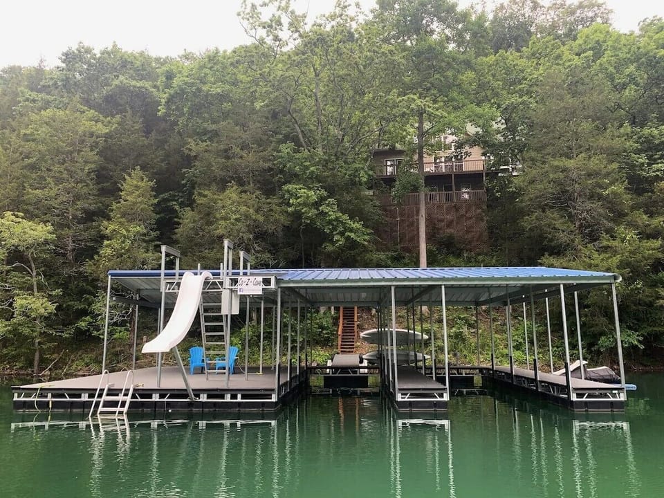 Dock with jumping platform, slide, 2 covered slips, 2 jet ski ports.