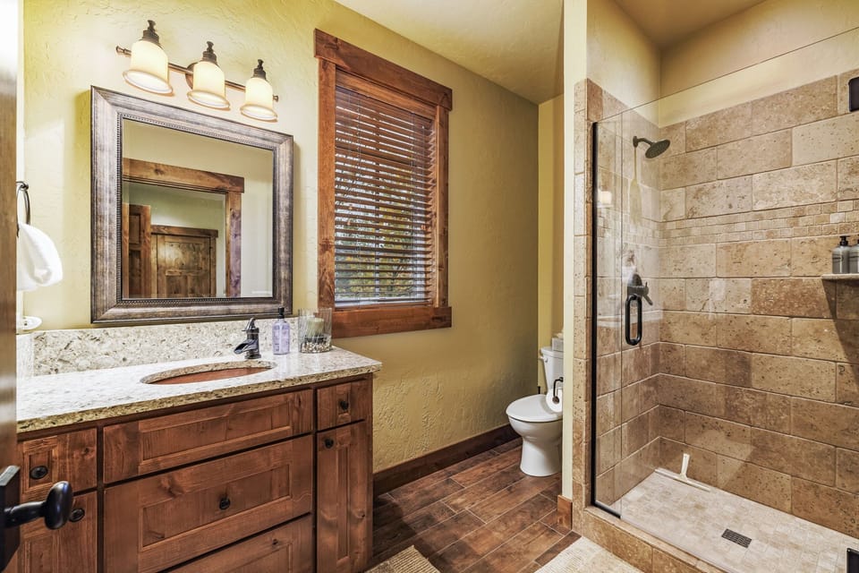 Experience the timeless beauty of natural stone in this en suite bathroom
