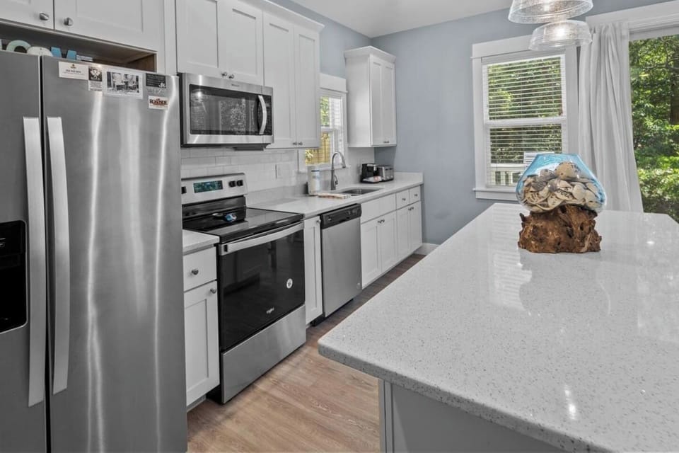 Modern kitchen with stainless steel appliances and everything you need to cook at home.