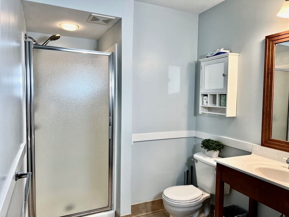 The second bathroom has a shower with an upgraded shower head and is not attached to the bedroom.
