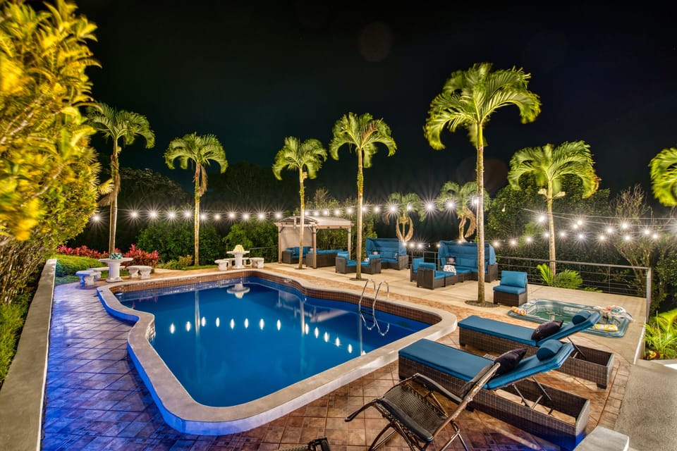 A softly lit pool area welcomes you at night.