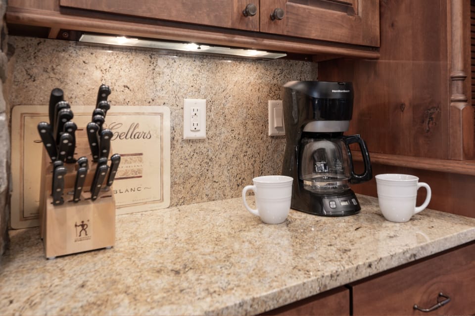 - Start your mornings with fresh brewed coffee from your private countertop station - Two mugs and warm under cabinet lighting invite slow mornings in the kitchen - Convenient layout with knife set and outlet keeps essentials within reach