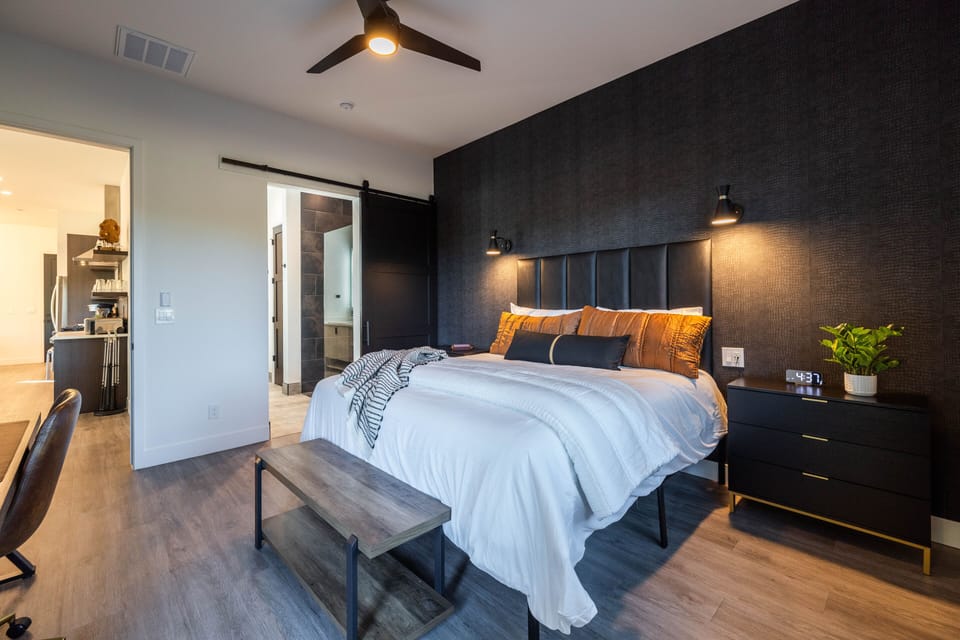 Master bedroom downstairs, with King size bed, en-suite bath, flat screen TV, desk and patio access