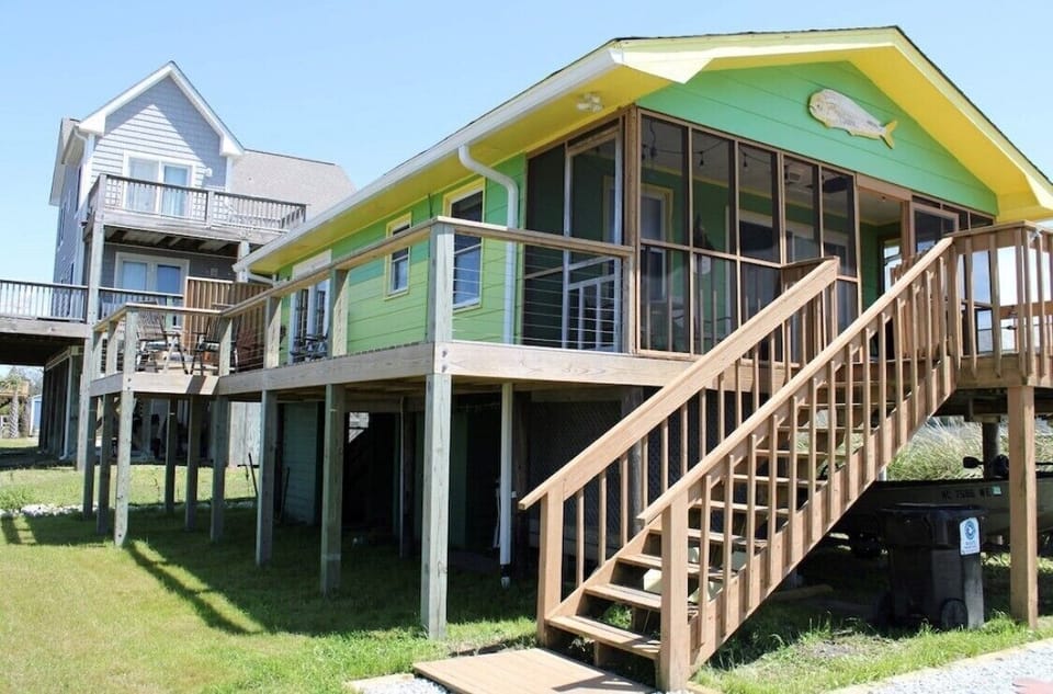 Steps leading to screen porch and wrap around deck.