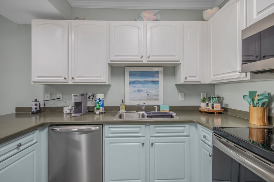 Kitchen is stocked with pots/pans/utensils.