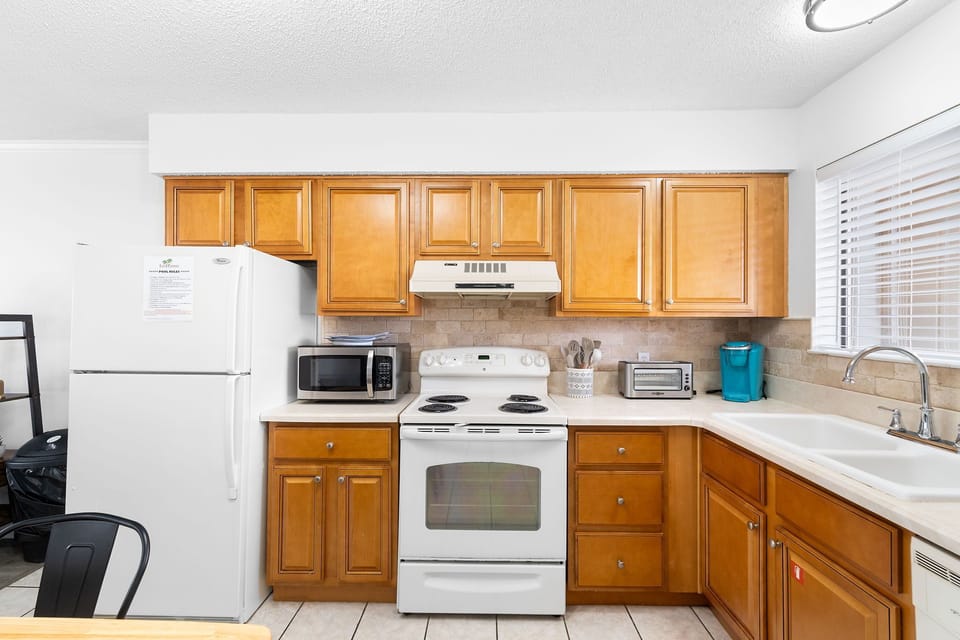Kitchen is stocked with pots/pans/utensils.
