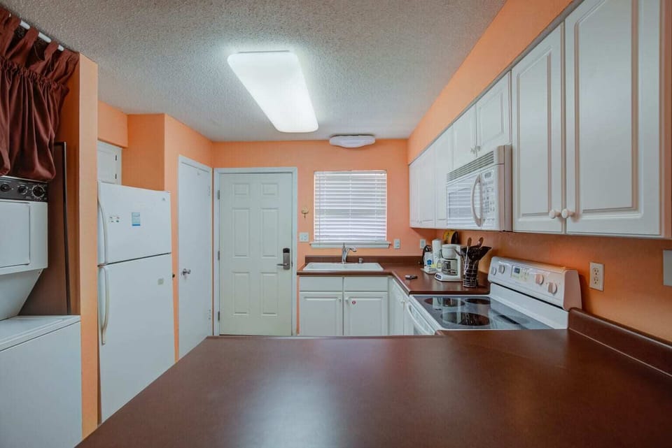 Well-equipped kitchen with pots/pans/utensils.