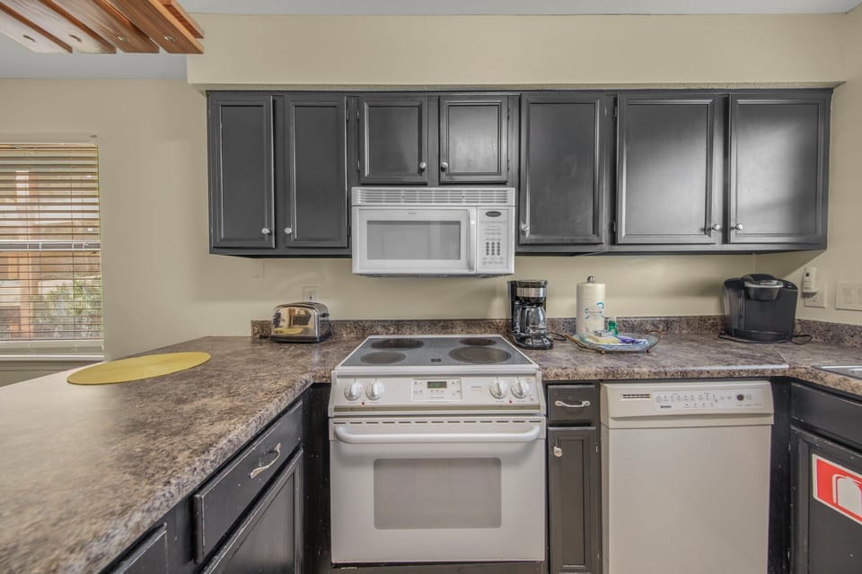 Kitchen is stocked with pots/pans/utensils.