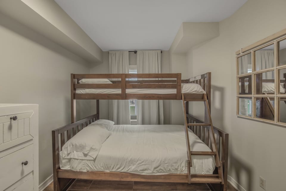 Third bedroom with bunkbed featuring a full-size bed on bottom and twin-size bed on top