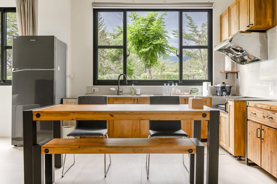 Deluxe Family Room | Private kitchenette | Fridge, electric kettle, cookware/dishes/utensils, dining tables