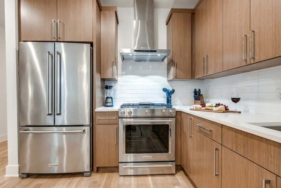 Stainless steel appliances and subway tile backsplash make this kitchen functional and beautiful for group cooking and meal prep