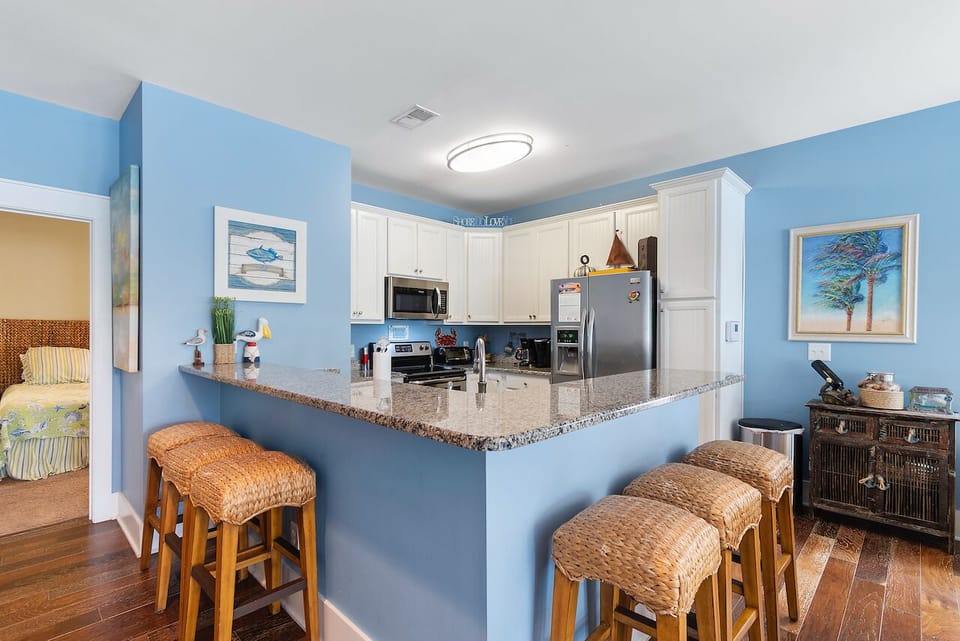Gather around this bright kitchen's granite breakfast bar for morning coffee or casual meals with family.