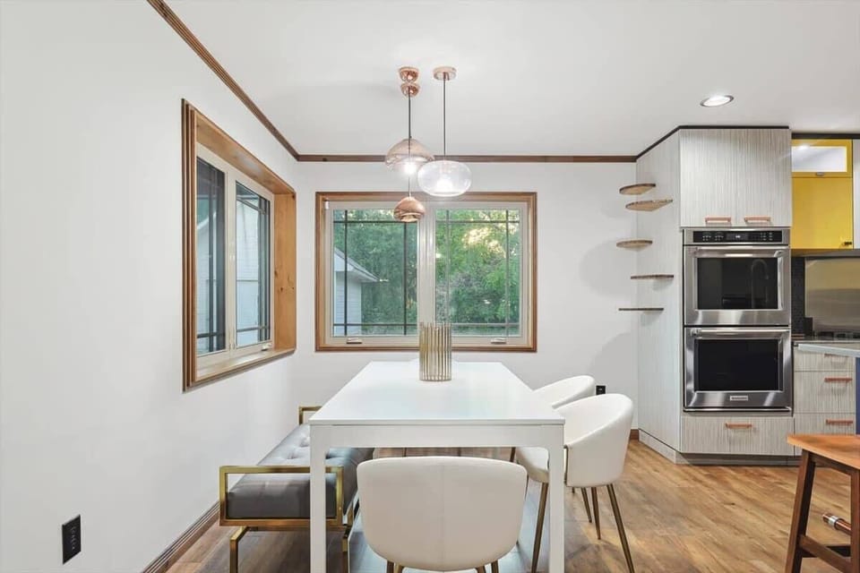 Come enjoy a lovely meal in this dining room, where this exceptional white dinner table is a centerpiece in and of itself!