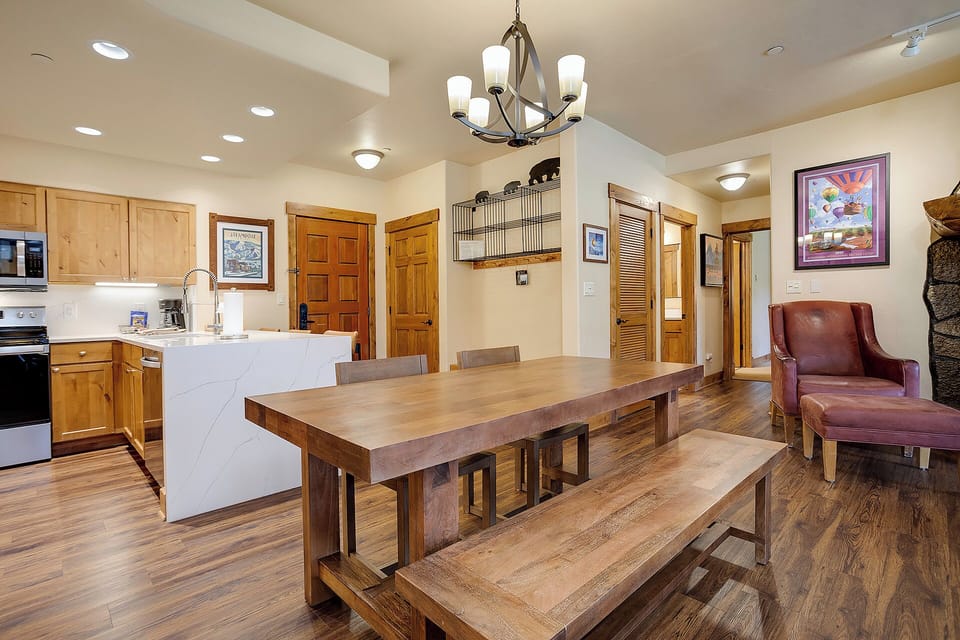 Step into your spacious open-concept haven where rustic charm meets modern comfort. Gather around the handcrafted dining table for memorable meals.