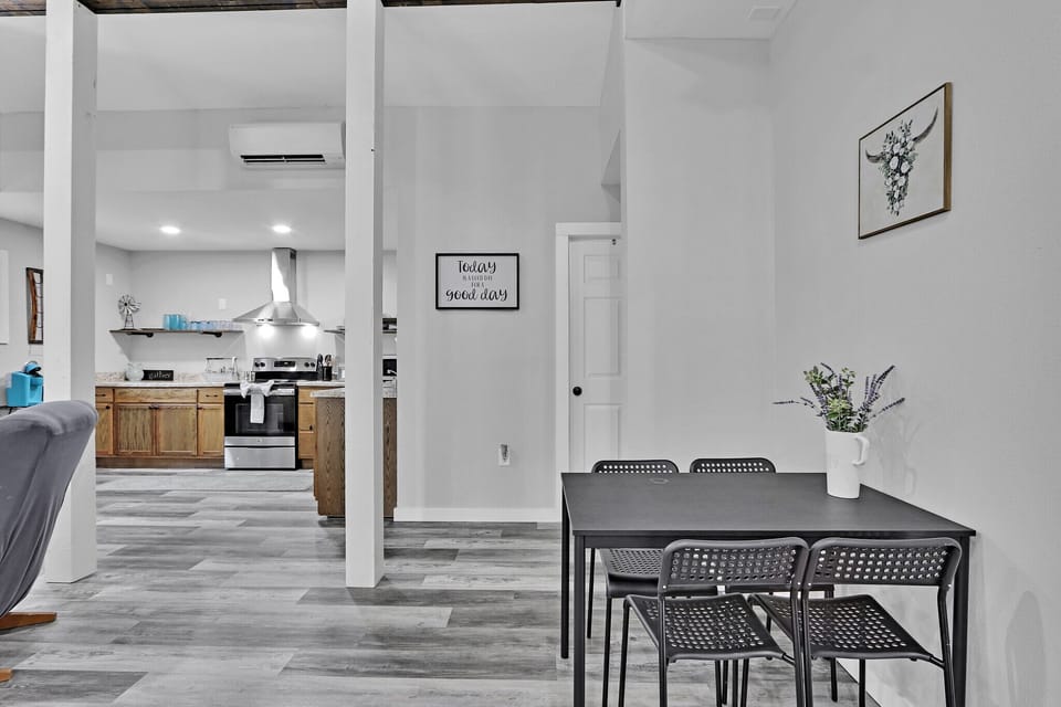 The dining is behind the living area, and the bathroom is through the door straight ahead