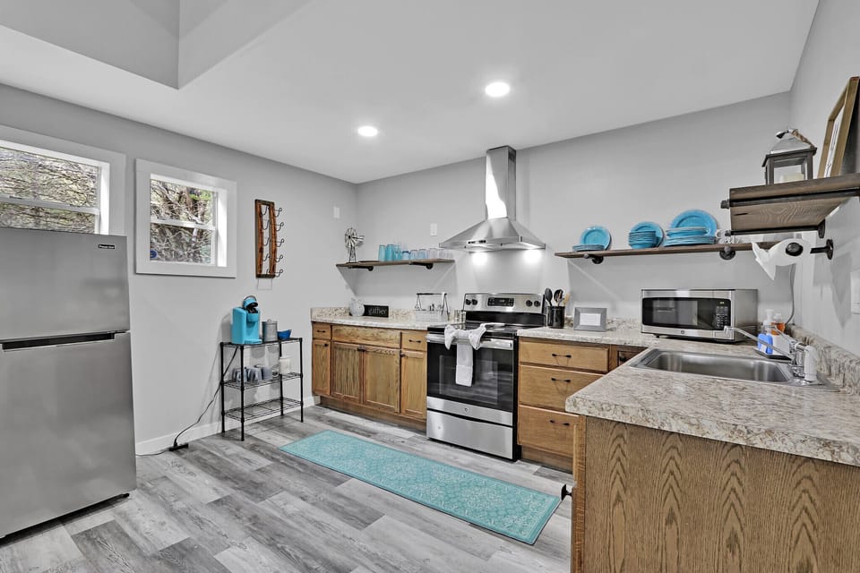 Exiting the bathroom and laundry area, looking into the kitchen