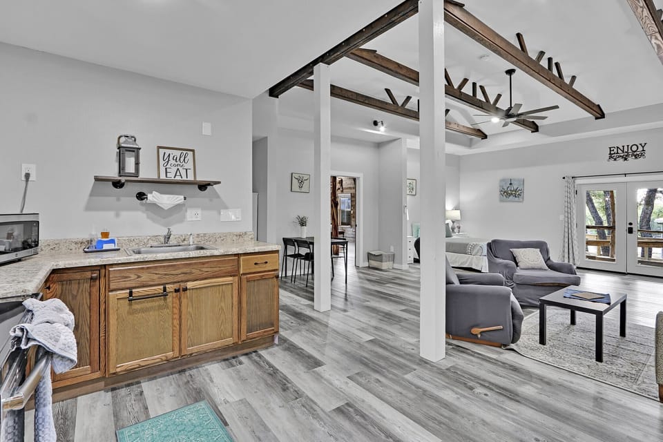 The doorway between the kitchen and living is the bedroom
