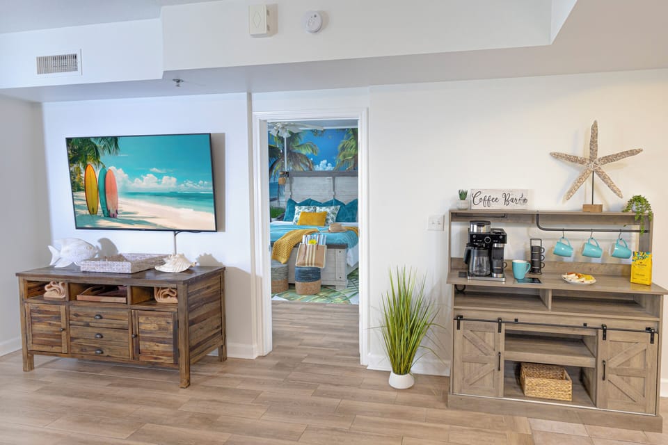 Coastal-themed living area with a coffee bar and beach-inspired decor.