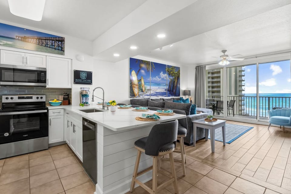 Modern kitchen and living area with ocean views and balcony access.