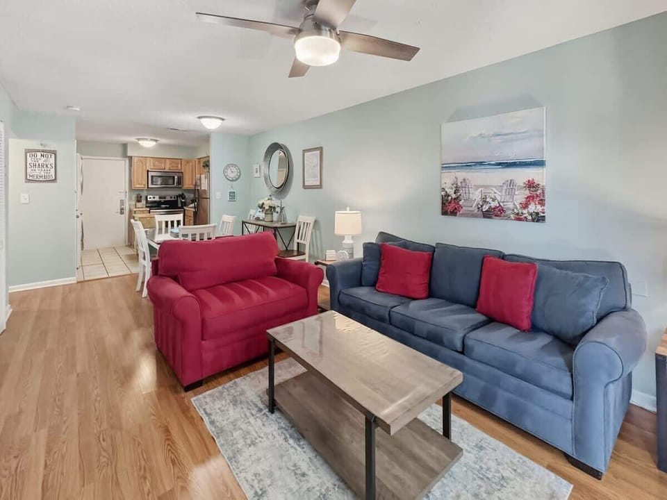 A comfortable space anchored by a large navy blue sofa.