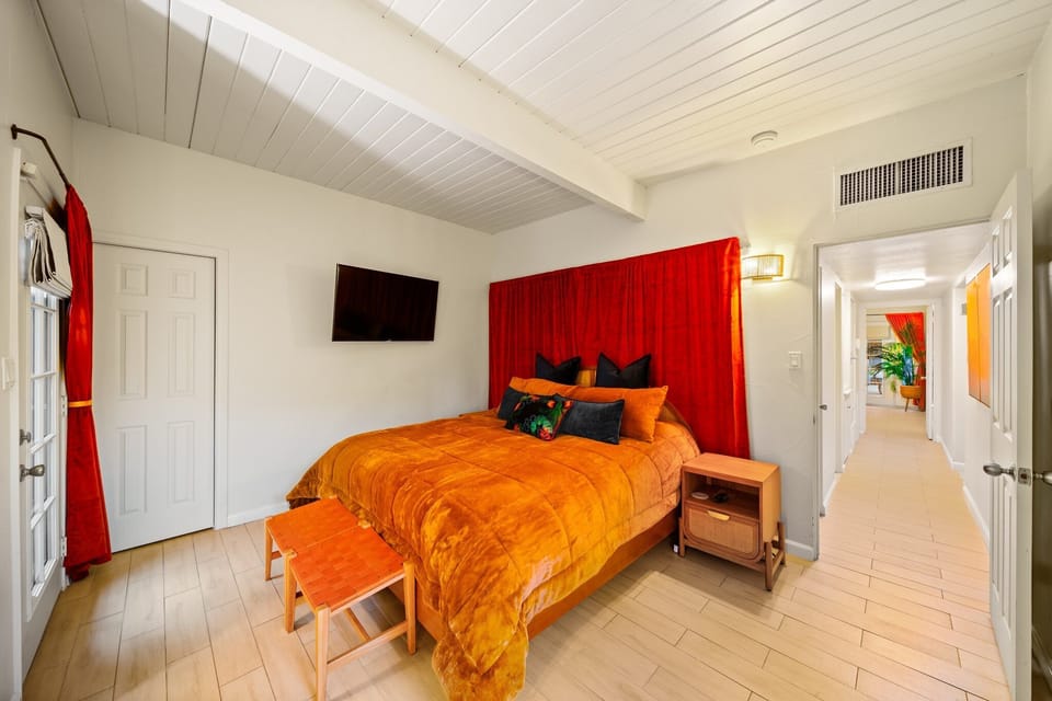 This stylish king bedroom with a wall-mounted TV 