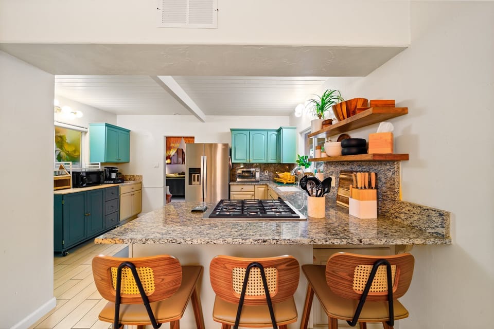 Spacious modern kitchen with bar seating for three.