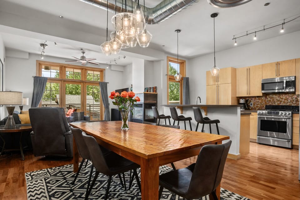 Dining in Style. Modern hanging lights over Dining Table and Kitchen Island