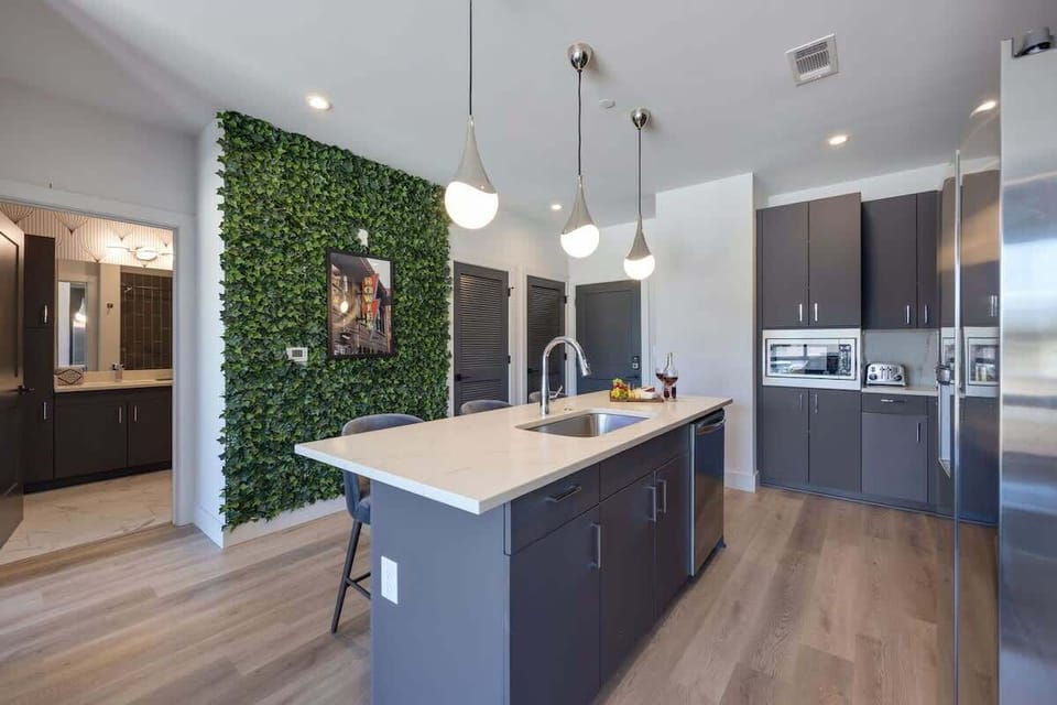 Fully equipped kitchen stocked with your basic cooking essentials. Includes stainless steel appliances, small kitchen island, coffee machine, and toaster.