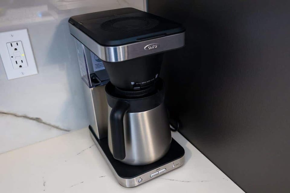Fully equipped kitchen stocked with your basic cooking essentials. Includes stainless steel appliances, small kitchen island, coffee machine, and toaster.