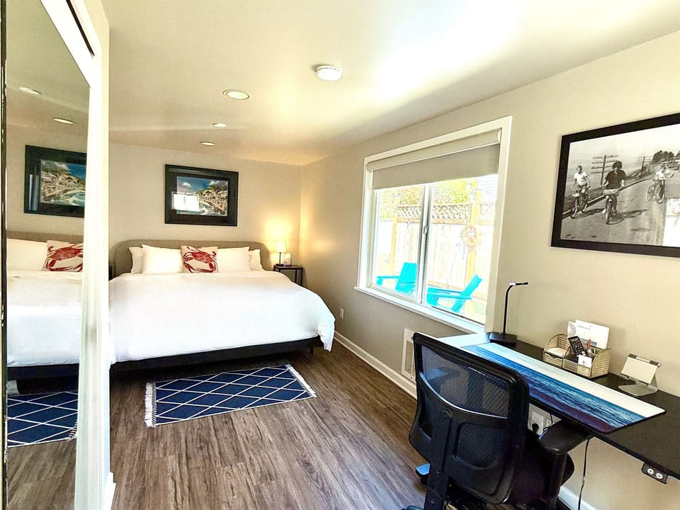 Spacious bedroom with comfy king bed, high quality linens, desk, closet, and windows for natural light!
