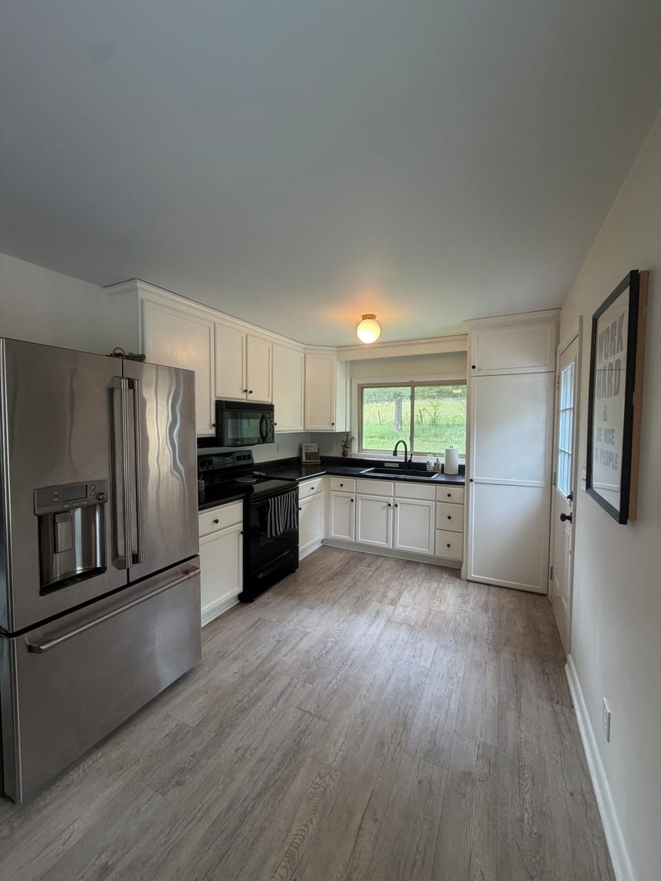 Full kitchen and stacked laundry