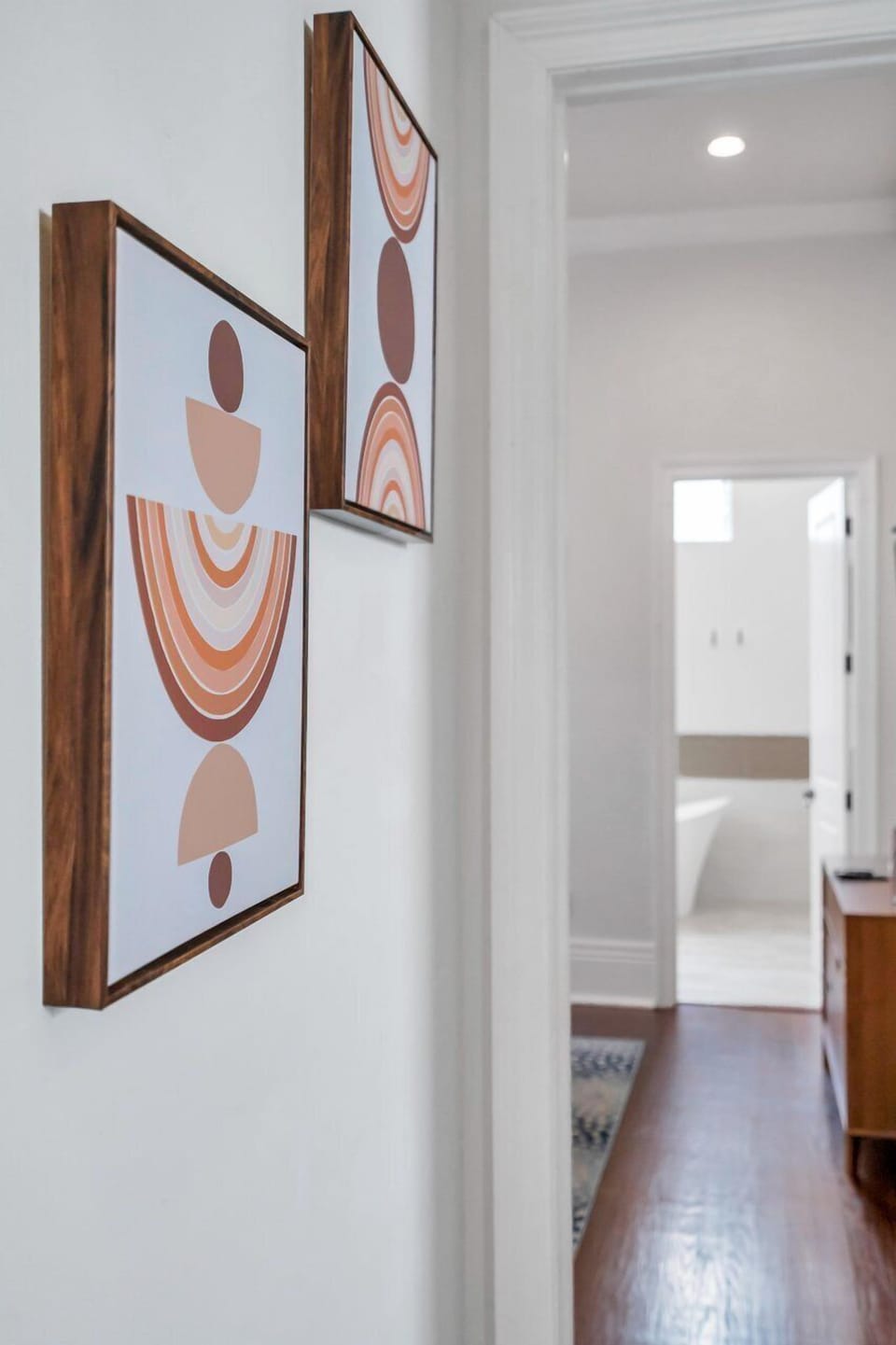 Eclectic art-lined hallway that sets a creative, welcoming tone.
