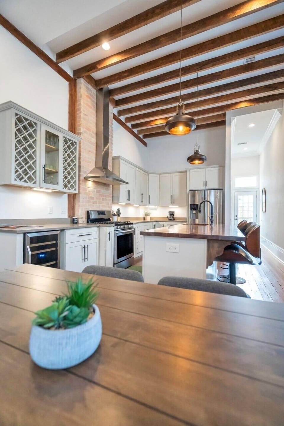 Bright kitchen w/ open shelving, tile backsplash & modern appliances.