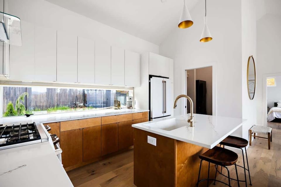 Whip up your favorites in this clean, contemporary kitchen complete with quartz countertops, gas range, and a glossy white aesthetic that makes everything feel fresh. Whether you’re brewing morning coffee or hosting happy hour, this space makes it ea